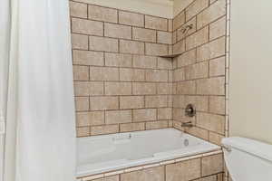 Full bathroom featuring shower / bath combo and toilet