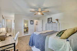 Carpeted bedroom featuring baseboards and a ceiling fan