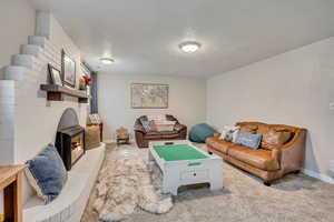 Living area featuring carpet flooring and baseboards