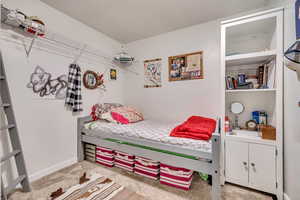 Carpeted bedroom with baseboards