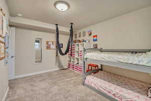 Bedroom with carpet floors and baseboards