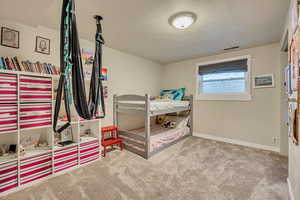 Bedroom with carpet and baseboards