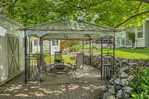 View of patio featuring a gazebo and an outdoor fire pit