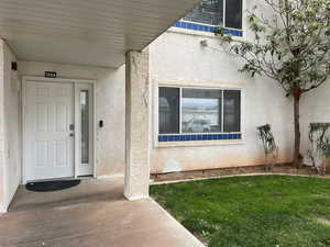 Property entrance with stucco siding