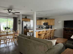 Living area featuring ceiling fan, dark wood-style flooring, baseboards, and recessed lighting