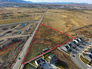 Aerial overview of property's location featuring property parcel outlined and a mountainous background