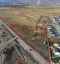 Aerial view of residential area with property boundaries highlighted and mountains