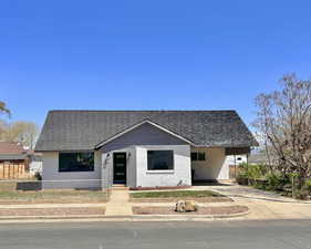 Bungalow-style house with concrete driveway, brick siding, and a carport