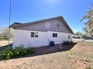 View of home's exterior featuring brick siding and central AC unit