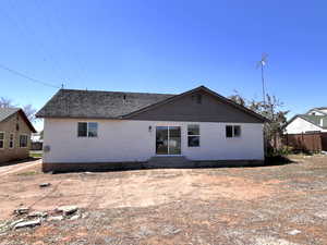 Rear view of house featuring entry steps and brick siding