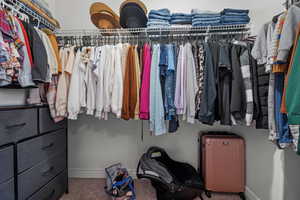 Spacious closet with carpet and radiator heating unit