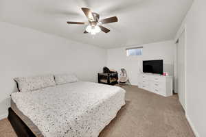 Bedroom featuring carpet, ceiling fan, and baseboards