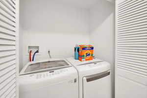 Washroom with washing machine and clothes dryer