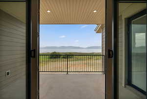 Balcony featuring a water and mountain view
