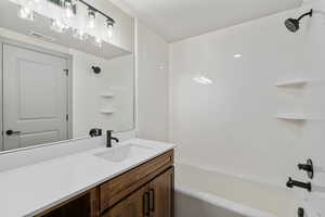 Bathroom featuring  shower combination and vanity