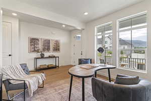 Living area with a mountain view, recessed lighting, and wood finished floors
