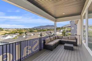 Deck with a residential view, an outdoor hangout area, and a mountain view