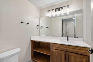 Half bath featuring vanity and toilet