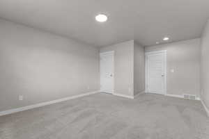Empty room featuring baseboards, carpet flooring, recessed lighting, and a textured ceiling
