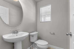 Bathroom with baseboards and toilet