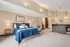 Guest suite or primary bedroom with wet bar and fireplace