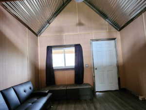 Unfurnished living room with wood finished floors, vaulted ceiling, and wood ceiling