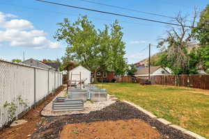 View of yard featuring a vegetable garden and an outbuilding