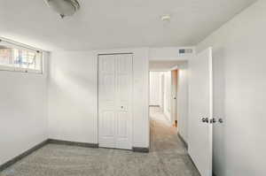Unfurnished bedroom with carpet flooring, baseboards, and a closet