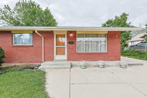 Single story home with brick siding