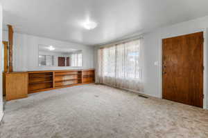 Unfurnished living room with carpet floors