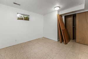 Below grade area with tile patterned floors and elevator