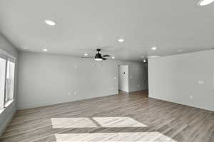 Empty room featuring recessed lighting, light wood-type flooring, ceiling fan, and baseboards