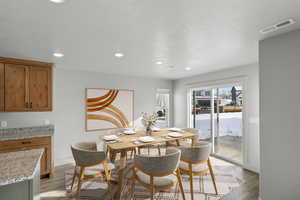 Dining space with light wood finished floors, recessed lighting, and baseboards