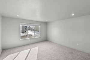 Spare room with carpet flooring, recessed lighting, and baseboards