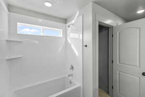 Full bath featuring bathing tub / shower combination