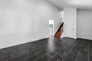 Entrance foyer with stairs and baseboards