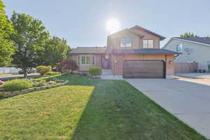 View of front of property featuring driveway, a garage, and brick siding