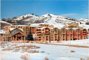 Snow covered property with a mountain view