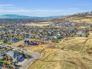 Aerial view of property's location featuring nearby suburban area and mountains