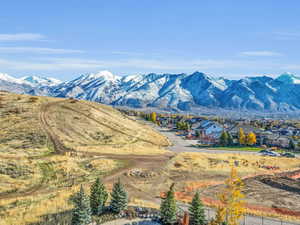 View of mountain backdrop featuring nearby suburban area
