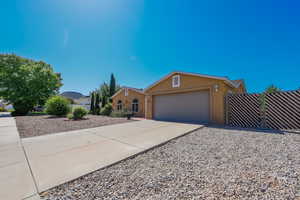 View of front facade featuring stucco siding, a garage, and concrete driveway