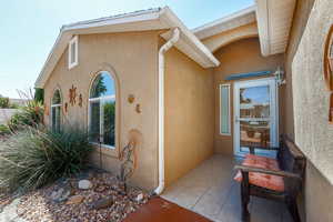 Entrance to property with stucco siding