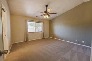 Unfurnished room featuring ceiling fan, carpet floors, baseboards, and a textured ceiling