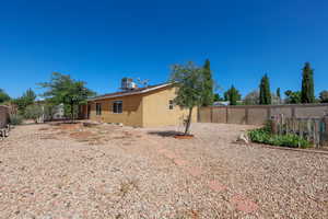 Fenced backyard featuring central AC unit