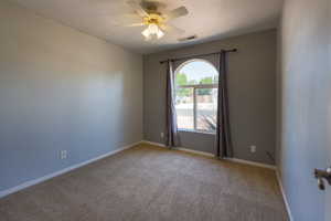 Spare room with ceiling fan, carpet, a textured ceiling, and baseboards