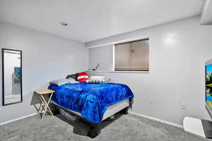 Carpeted bedroom featuring baseboards