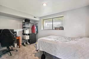 Bedroom with carpet and a desk