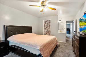 Carpeted bedroom with baseboards and a ceiling fan