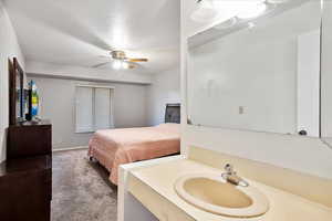 Bathroom featuring ceiling fan and vanity