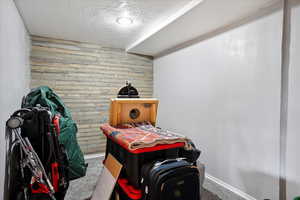 Carpeted bedroom featuring wood walls and baseboards